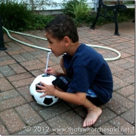 pumping up his soccer ball