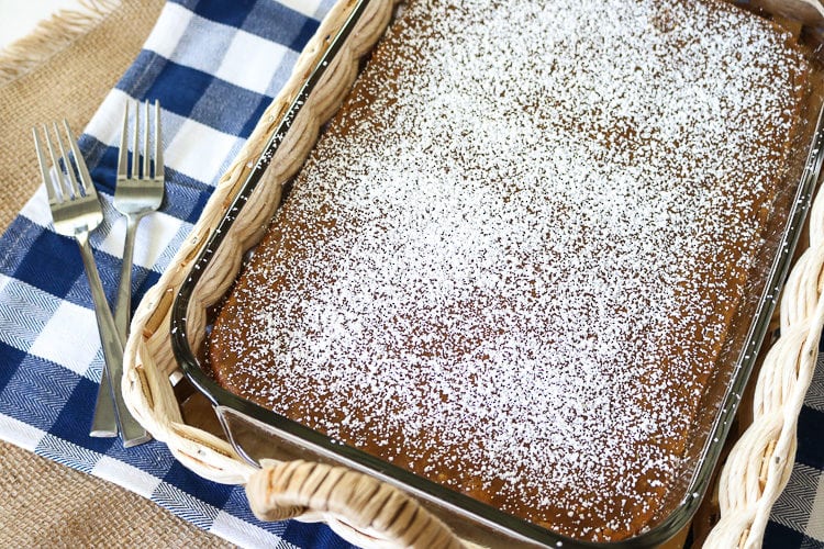 Pumpkin Gooey Butter cake with powdered sugar in a 9 x 11 glass pan