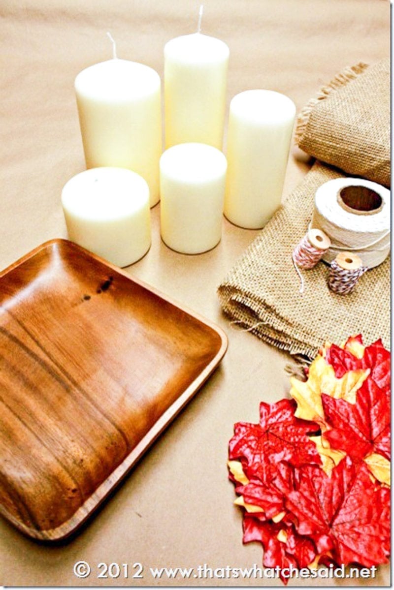 Make a Fall Candle Centerpiece with easy craft supplies: twine, fake leaves, candles and charger