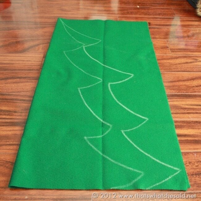Green felt folded in half and Christmas tree design drawn in white chalk