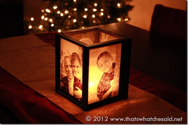 A picture frame luminary illuminated and at night. Glowing. 