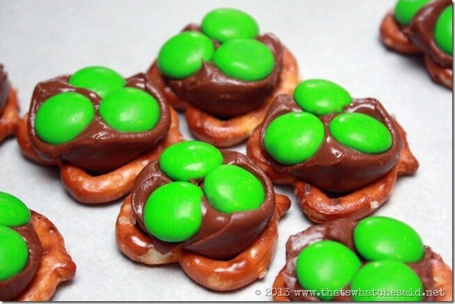 Adding green m&m candies to the pretzel and milk chocolate base. 