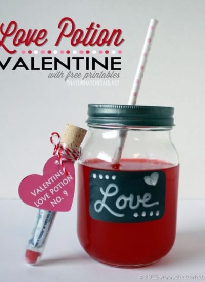 Mason Jar with lid an straw next to a test tube "love potion" valentine with heart tag