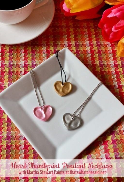 Three thumbprint heart necklaces made from oven bake clay and metallic paint.