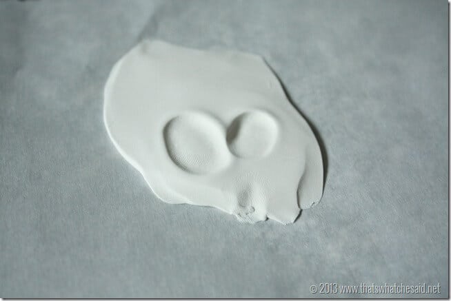 Pressed clay with thumbprints in a v shape