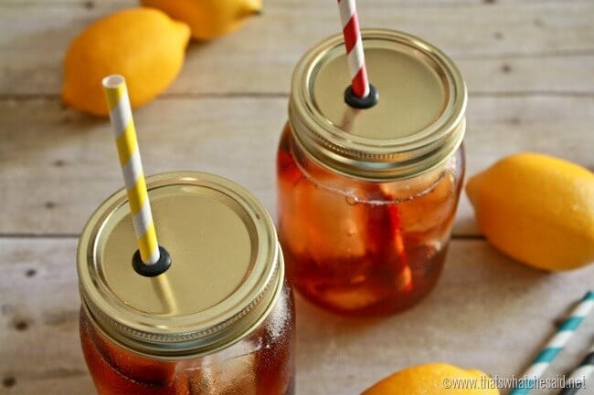 DIY Mason Jar Straw Lids. 2 jars with straw lids and lemons in the background.