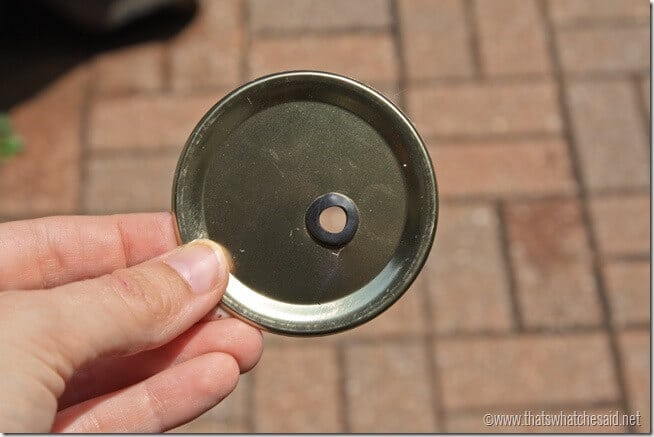 Mason Jar lid with hole drilled and rubber grommet inserted. 