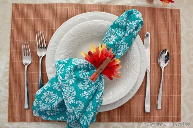Place setting with turkey napkin rings made from faux flowers and clothespins