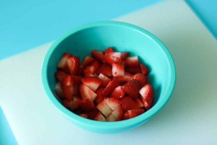 Cut strawberries for red layer of push pops