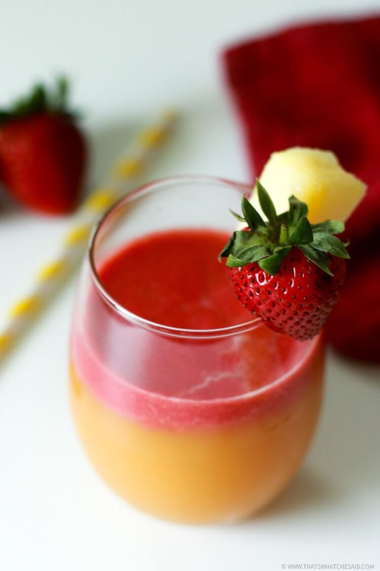 Strawberry puree on top of Pineapple Orange Margarita