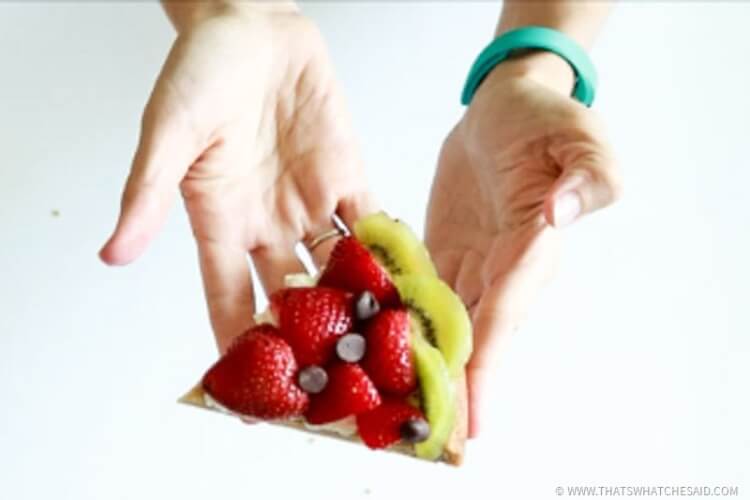 Kiwis, sliced strawberries and chocolate chips make this fruit pizza the perfect slice of watermelon!