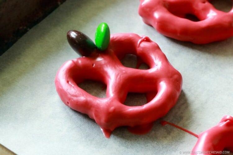 Pretzel dipped in red candy melts and M&M's to garnish like an apple