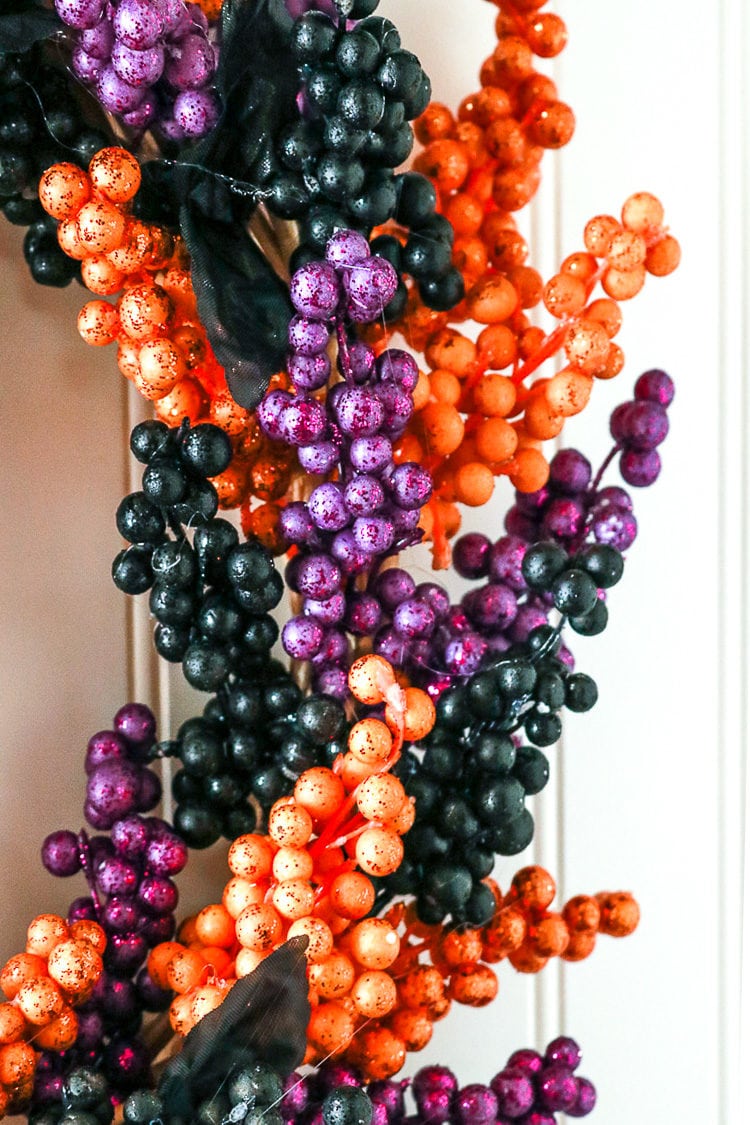 Close of up view of how the berry sprigs are glued to the wreath form