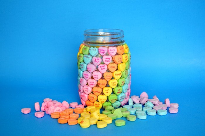 Mason Jar covered in Candy Hearts in Rainbow order