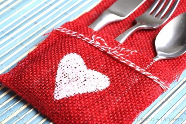 Red burlap utensil holder with painted white heart and twine