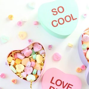 Paper mache heart boxes painted to look like conversation hearts