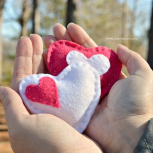 Hands holding heart hand warmers