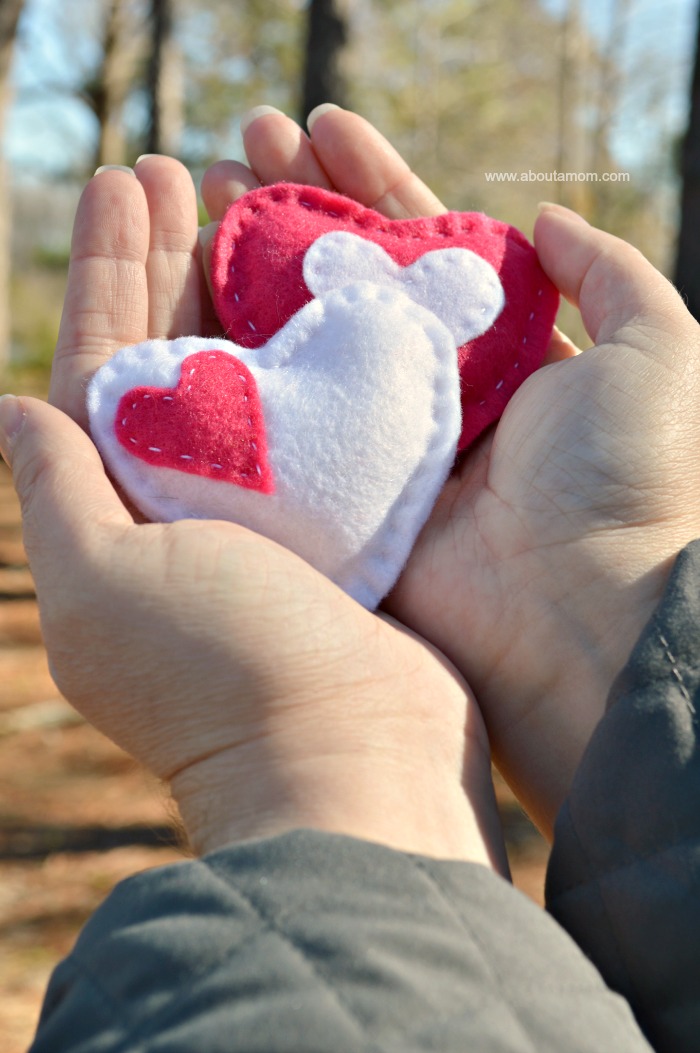 Hands holding heart hand warmers