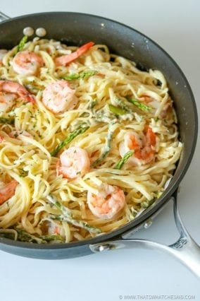 Garlic Butter Shrimp Pasta in skillet on white background