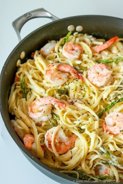 Skillet with shirmp pasta and asparagus in a white wine garlic butter sauce