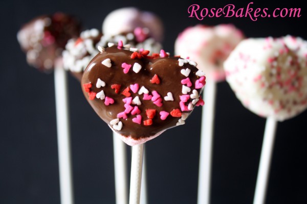 Heart Mashmallows covered in chocolate with sprinkles on sticks