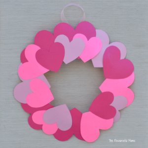 Paper hearts glued on paper plate with center cut out to create heart paper wreath