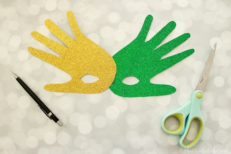 Handprint Mardi Gras Masks - Carefully cut out spots for the eye holes.