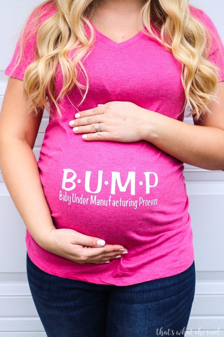 Pregnant woman in pink shirt.  Shirt reads BUMP Baby Under Manufacturing Process on her belly in Cricut SportFlex Iron-on.