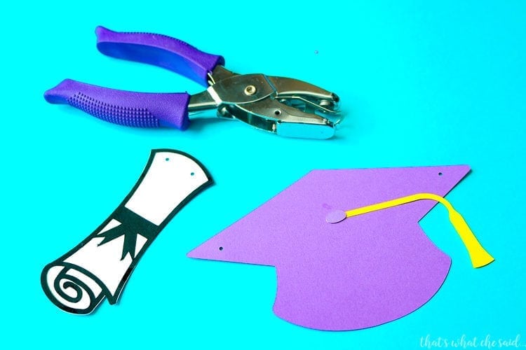 Paper Diplomas & Paper Graduation Hats punch with a Eighth inch hole punch.