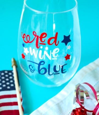 Patriotic Wine glass with American Flag and some red white and blue curling ribbon.