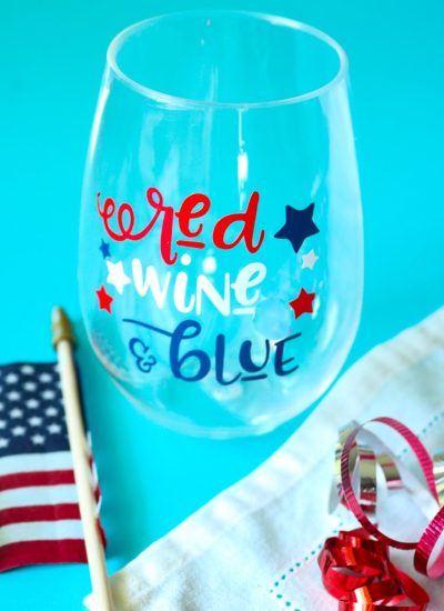 Patriotic Wine glass with American Flag and some red white and blue curling ribbon.