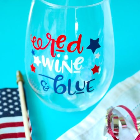 Patriotic Wine glass with American Flag and some red white and blue curling ribbon.