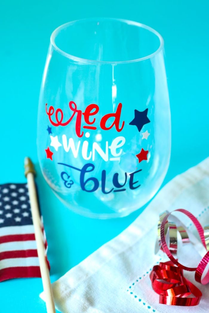 Patriotic Wine glass with American Flag and some red white and blue curling ribbon.