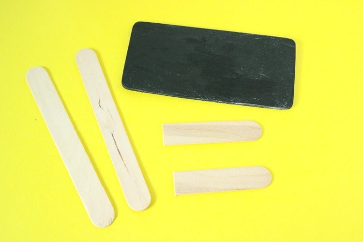 small chalkboard painted rectangle with popsicle sticks