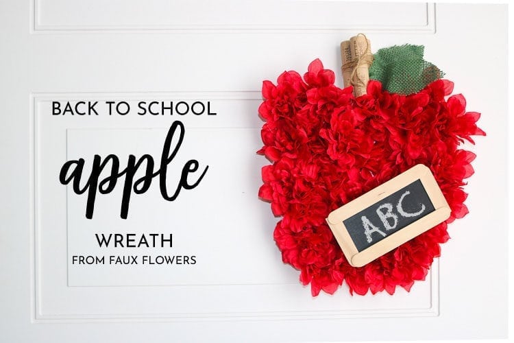 Apple wreath made with faux flowers and small craft chalkboard
