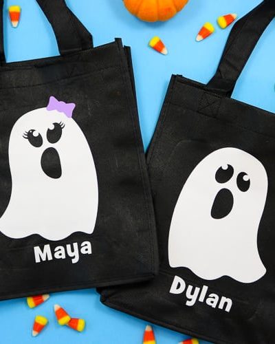 Black reusable tote bags with white boy and girl ghost decals