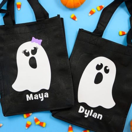 Black reusable tote bags with white boy and girl ghost decals