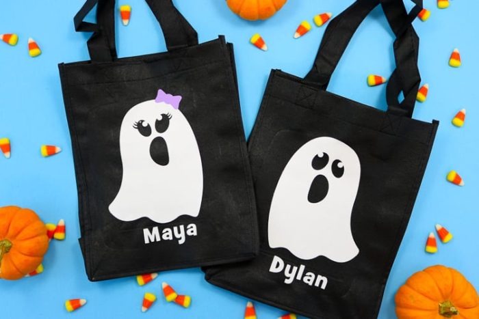 Black reusable tote bags with white boy and girl ghost decals