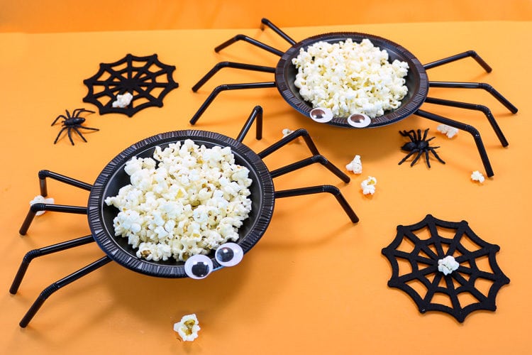 Spider bowls made from plastic bowls and straws filled with popcorn