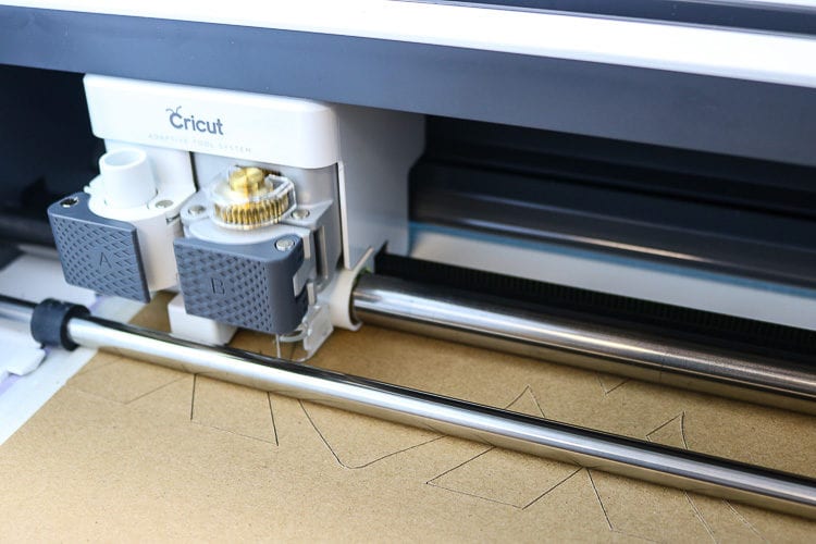 Close up view of the Cricut Maker cutting into Chipboard with the Knife Blade