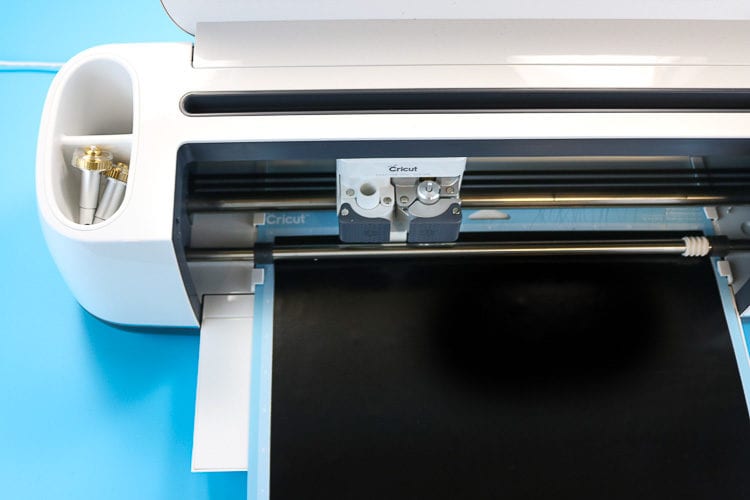 Cricut Maker Machine cutting black iron 