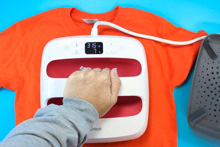 Pressing an Orange T-Shirt with an EasyPress to make Jack-o-Lantern shirt with sunglasses