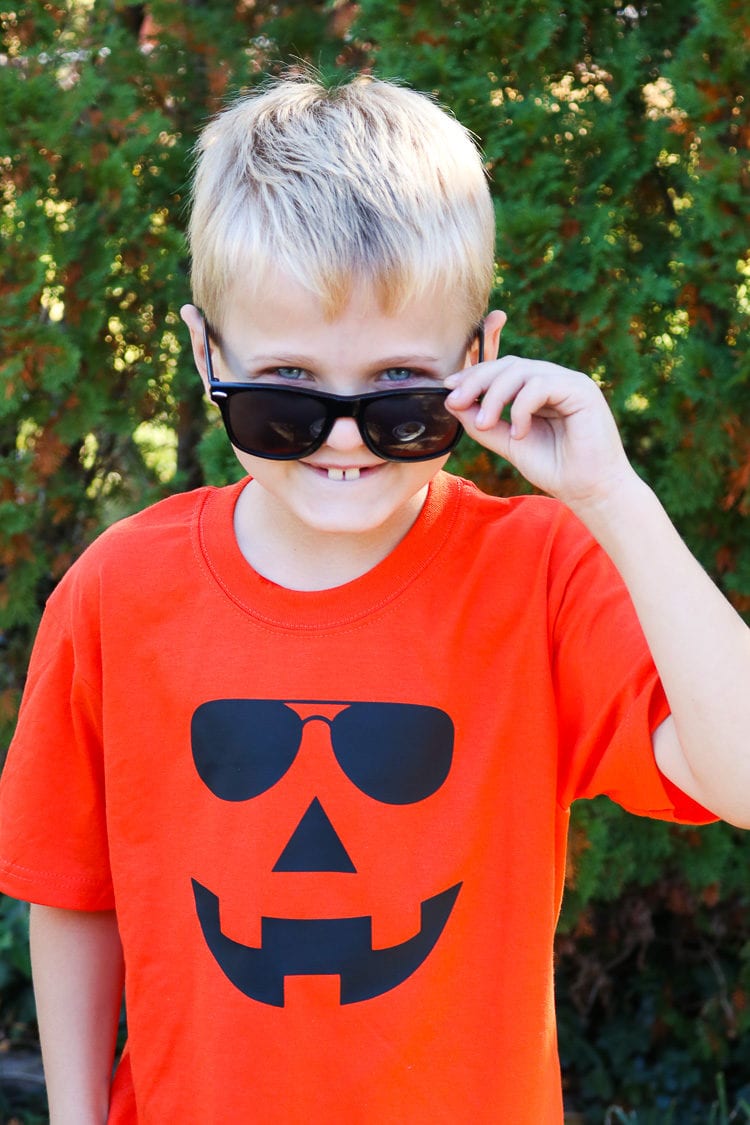 Boy sporting Orange Jack-o-lantern Shirt with sunglasses on