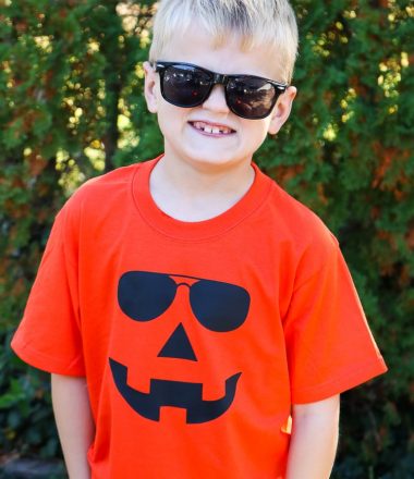 Boy sporting Orange Jack-o-lantern Shirt with sunglasses on