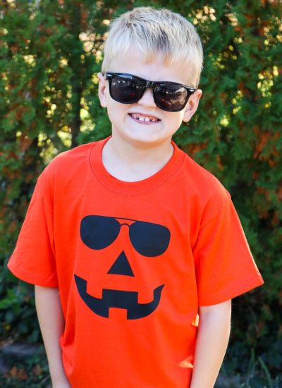 Boy sporting Orange Jack-o-lantern Shirt with sunglasses on