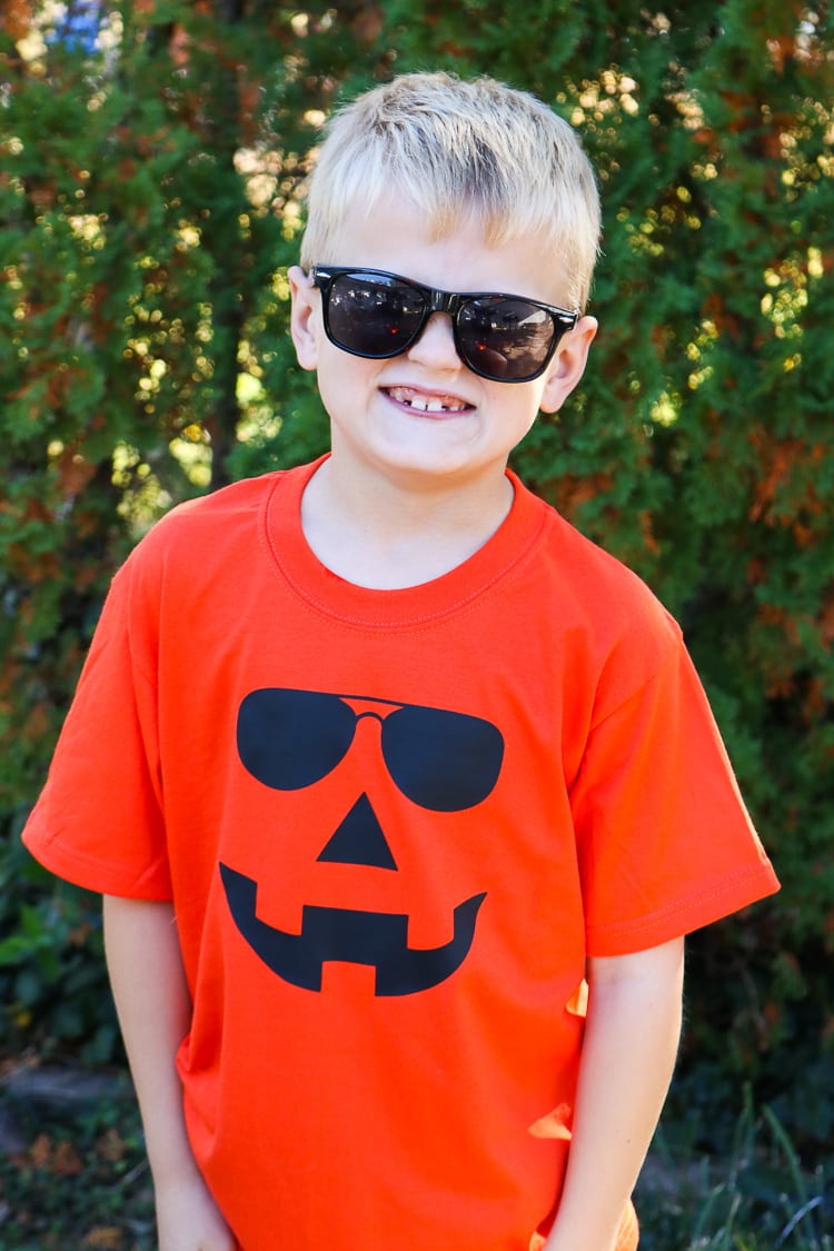 Boy sporting Orange Jack-o-lantern Shirt with sunglasses on