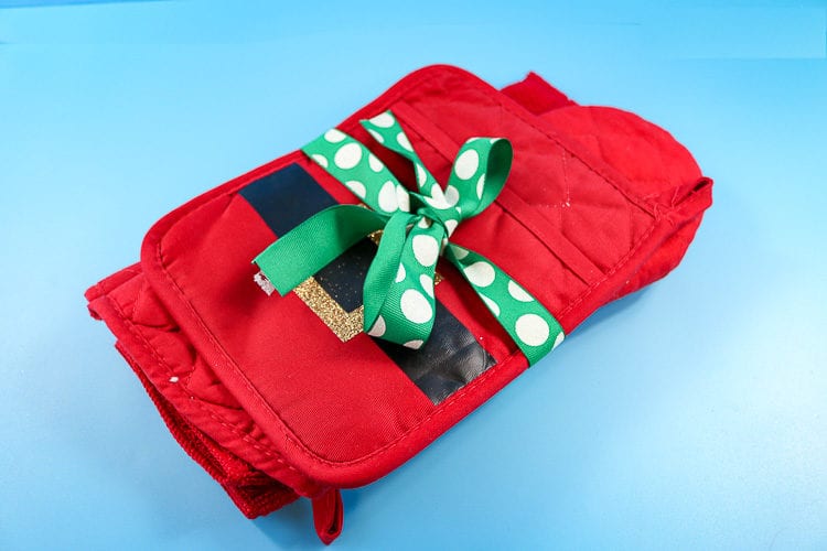 Hot Pad, Oven Mitt and Dish Towel wrapped up with a ribbon perfect for an inexpensive gift idea