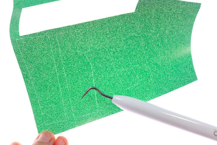 Close Up shot of how Bright Pad helps to see weeding lines on materials such as glitter iron on