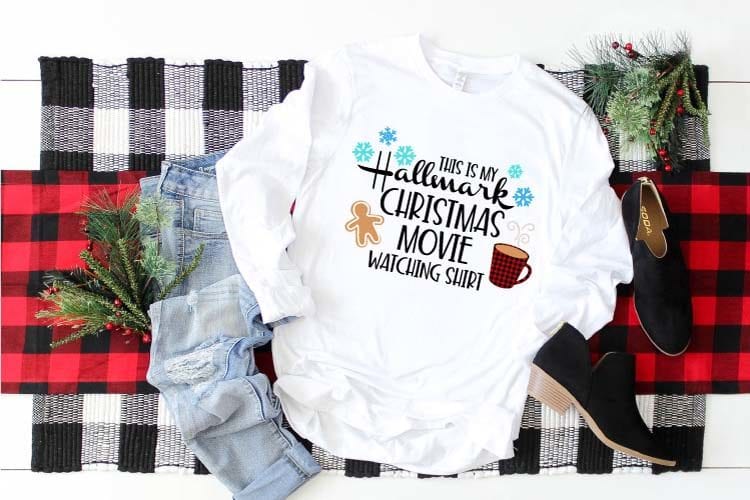 Cozy T-shirt with Hallmark Christmas Movie Watching SVG pressed on. 