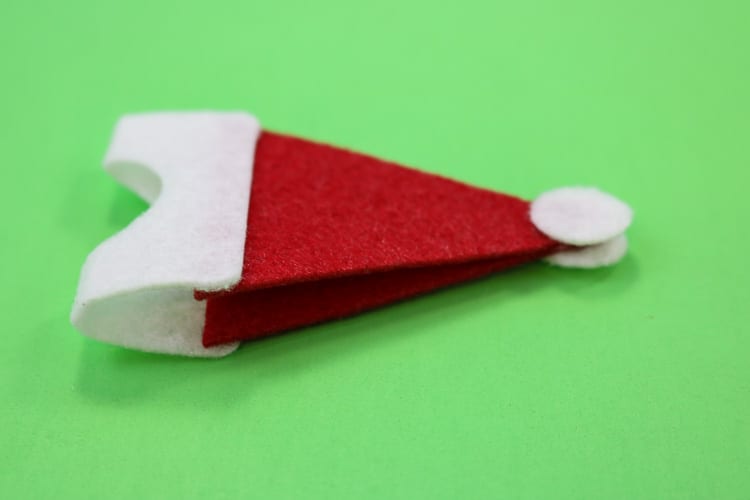 Last Santa Hat Assembly step is to add white circles to both sides of the Santa hat